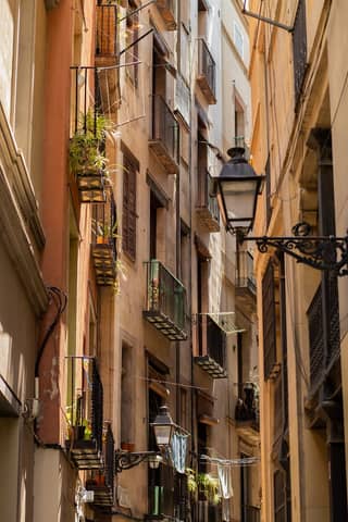 Explore the narrow streets of Barcelona's Gothic Quarter, showcasing historic architecture and quaint balconies.