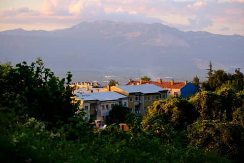 Picturesque scenery of residential area with mountains at sunset.