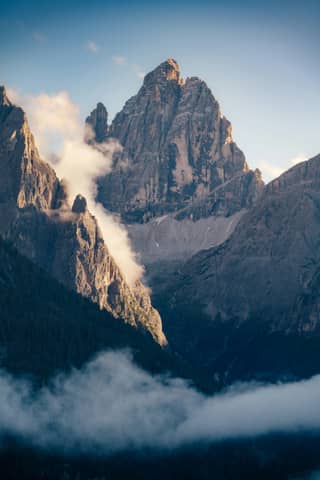 A mountain range covered in fog and clouds