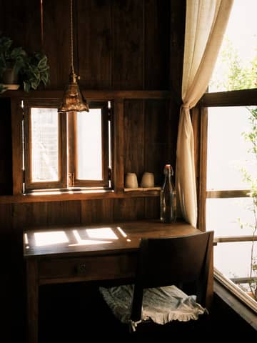 Charming rustic room with wooden desk and natural lighting.