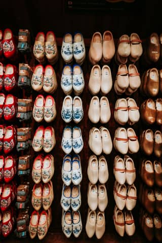 Colorful dutch wooden clogs displayed in a shop.
