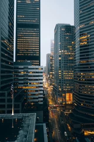 City buildings at night with lights on.