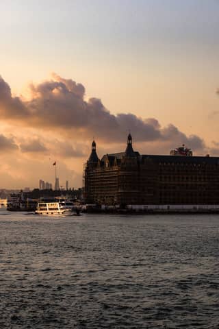 Scenic sunset view of Haydarpaşa Terminal in Istanbul, with ferry on the Bosphorus.