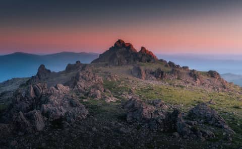 Mountain top illuminated by a gorgeous sunset.