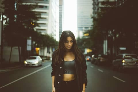 A woman standing in the middle of a street