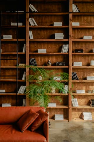 Bookshelves and a sofa create a cozy reading nook.
