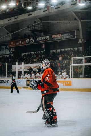 A hockey player on the ice in an arena