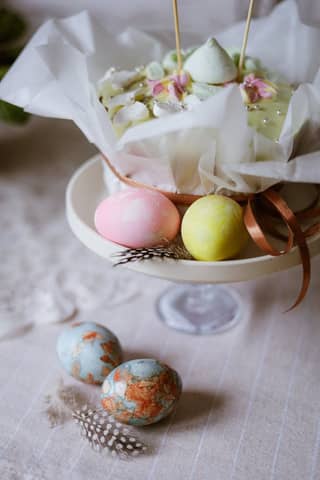 Colorful Easter eggs and a whimsical cake create a festive holiday display.