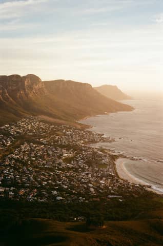 Coastal town nestled at the base of mountains.