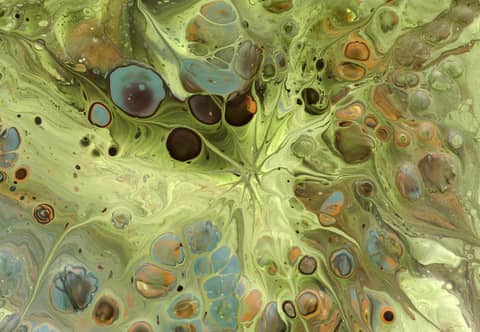 An abstract fluid painting featuring swirling earthy tones and vibrant shapes, creating a mesmerizing effect.