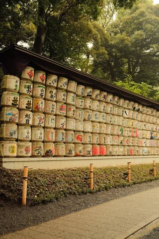 Traditional sake barrels on display at Meiji Shrine in Tokyo, showcasing cultural heritage.