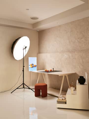 A room with a white table and a white light