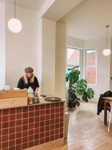A person standing at a counter in a room