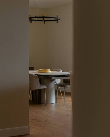 A dining room is framed through a doorway.