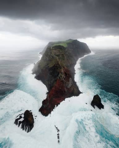 A large body of water next to a cliff