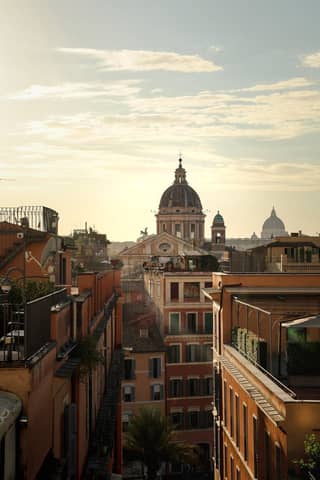 Discover the captivating view of Rome's architecture during a golden sunset, showcasing historic charm.