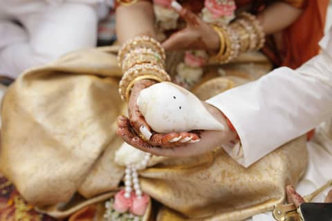 A man and a woman sitting down holding something in their hands