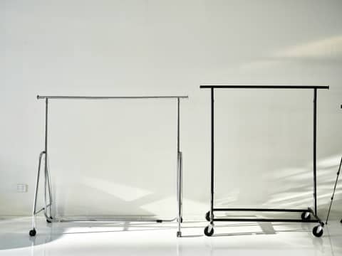 A white room with a black rack and a white wall