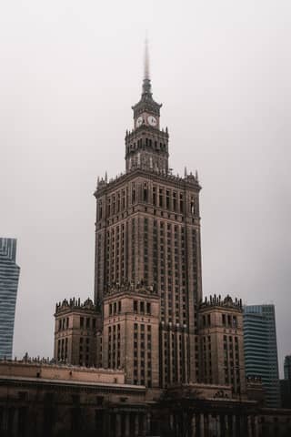 A grand clock tower standing tall against an overcast sky, showcasing architectural elegance.