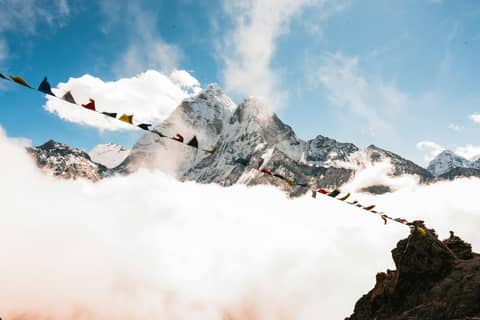 Himalayan Range with Prayer Flags  Above the Clouds