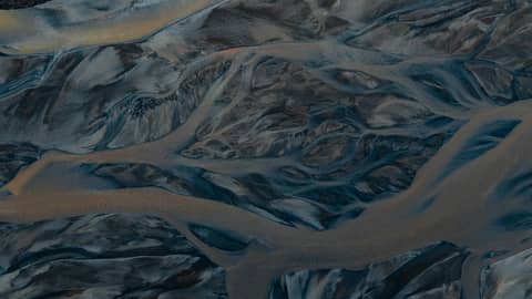 A river delta flows, forming beautiful patterns.