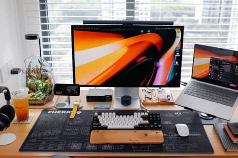 A sleek, modern desk setup with multiple screens.