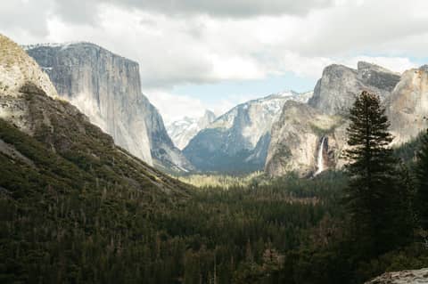 A view of a valley with mountains in the background