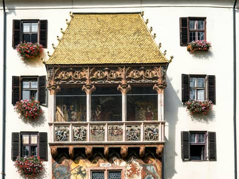 The historic Golden Roof in Innsbruck's old town, showcasing ornate architecture and floral decoration.