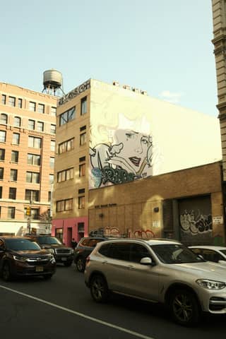 A large mural adorns a building in the city.
