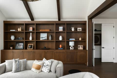 A cozy living room with built-in shelves.