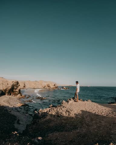 Man enjoying the tranquil coastal landscape in San Juan de Marcona, Peru.