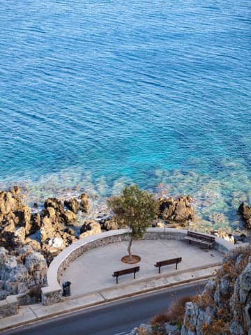 Beautiful coastal view in Greece overlooking azure waters and rocky shore. Ideal travel destination imagery.