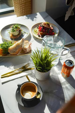 Delicious brunch spread with coffee and water.
