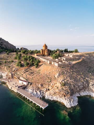 A stunning aerial shot of Akdamar Island with the historic church surrounded by the beautiful Lake Van.