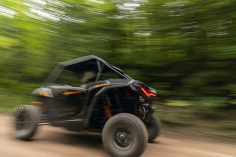 A person riding a four wheeler on a dirt road