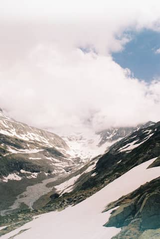 Scenic view of a majestic snowy mountain under a cloudy sky, perfect for nature lovers.